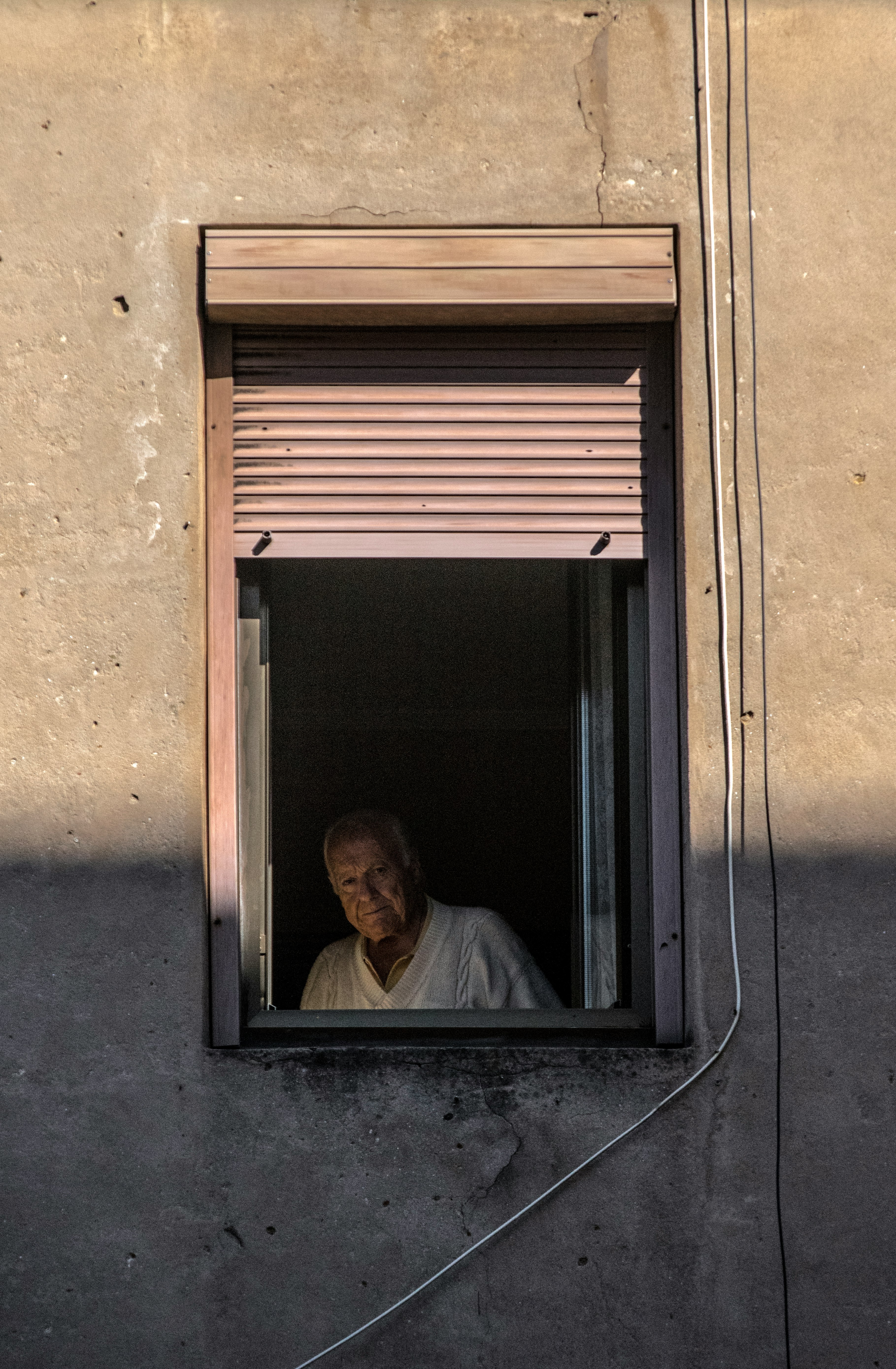 man in white dress shirt sitting on window